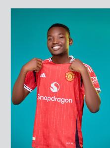 a young boy wearing a red soccer jersey at Fournine Media in Mulanje