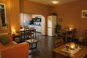 a living room with a couch and tables and a refrigerator at Jopi Hostel Katowice Centrum in Katowice