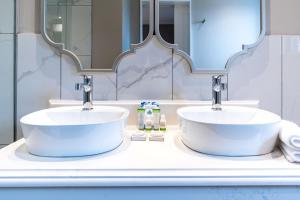 a bathroom with two sinks and a mirror at Premier Express Inn George in George