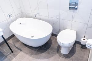a white bathroom with a toilet and a sink at Premier Express Inn George in George