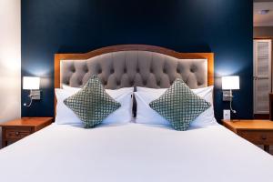 a bedroom with a large bed with two pillows at Premier Express Inn George in George