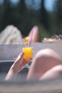 a person holding a glass with a drink at Alacati Naz Konak in Çeşme