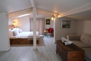 a hotel room with a bed and a couch at Alacati Naz Konak in Çeşme +20 photos