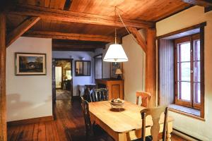 a dining room with a wooden table and chairs at Le Clos des Brumes Chalet in Chateau Richer