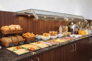 a buffet line with many different types of food at Hotel Wania in Hamburg