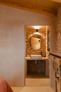 a bathroom with a stone wall and a sink at Habitació EL GRANER in Rasquera +16 photos