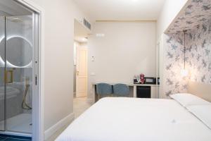 a bedroom with a king sized bed and a bathroom at Piazza Duomo Guest House in Ariano Irpino