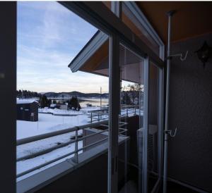 a window of a house with a view of the snow at Elan Villa Nojiri in Shinano