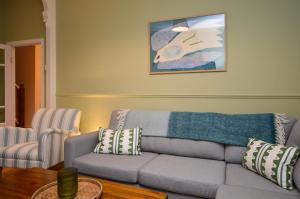 a living room with a couch and a table at Dunmore Argyll House in Dunoon
