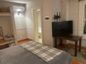 a bedroom with a bed and a flat screen tv at eastwood in San Carlos +19 photos