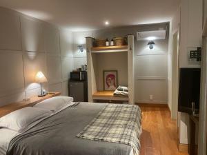 a bedroom with a large bed and a kitchen at eastwood in San Carlos