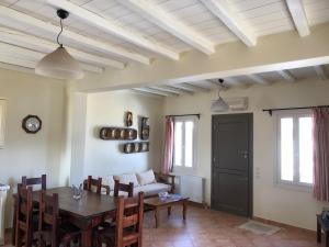 a living room with a table and a couch at To Diko Mas House in Stení