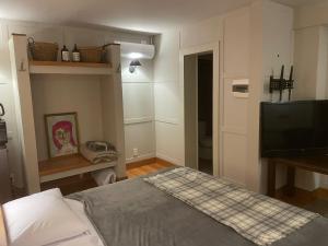 a bedroom with a bed and a flat screen tv at eastwood in San Carlos