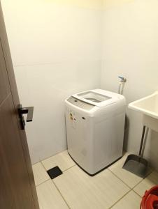 a small white bathroom with a toilet and a sink at Ebenezer in Cochabamba