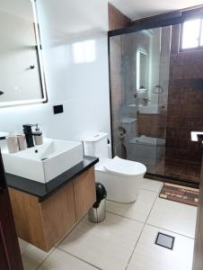 a bathroom with a sink and a toilet and a shower at Ebenezer in Cochabamba