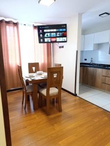 a kitchen and dining room with a table and chairs at Ebenezer in Cochabamba +2 photos