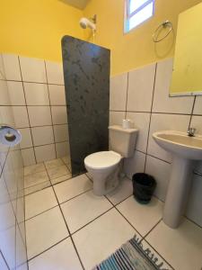 a bathroom with a toilet and a sink at Pousada Embaubas in Serra do Cipo +68 photos