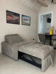 a bedroom with a bed and a table in it at CastelFidardo Dimore - MONOPOLI in Monopoli