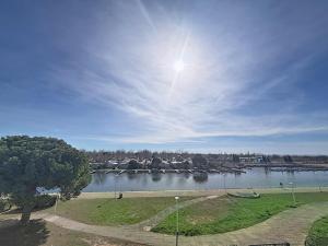 a view of a river with a marina at Studio 4 pers La Lagune in Le Grau-du-Roi