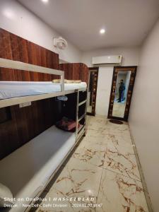 a room with two bunk beds and a marble floor at The Charlie Backpackers in New Delhi