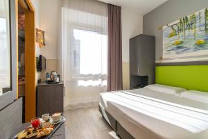 a bedroom with a large bed and a window at Hotel Aphrodite in Rome +104 photos