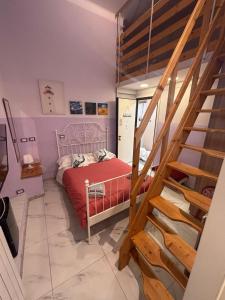 a bedroom with a red bed and a staircase at Oceania in Genoa