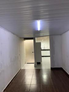 an empty room with a light on the ceiling at Casa para MotoGP in Goiânia
