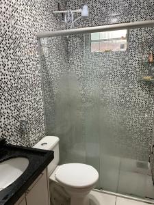 a bathroom with a shower and a toilet and a sink at Casa para MotoGP in Goiânia