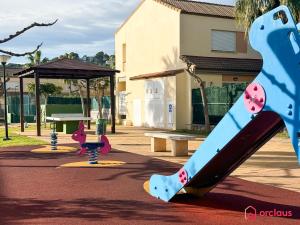 a playground with a slide in a park at El Embarcadero in Oropesa del Mar +49 photos