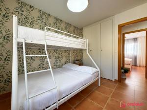 a bedroom with two bunk beds in a room at El Embarcadero in Oropesa del Mar