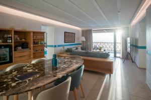 a living room with a table and chairs and a couch at The View Agadir in Agadir