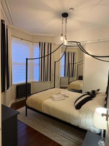 a bedroom with a bed with a large mirror at Grosvenor 126 Trendy Jesmond Whole Apartment in Jesmond