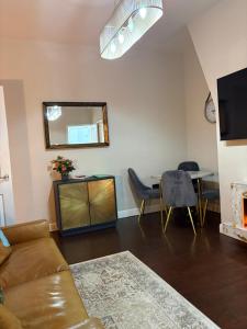a living room with a couch and a table at Grosvenor 126 Trendy Jesmond Whole Apartment in Jesmond