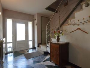 a hallway with a staircase with a vase of flowers at Traditional Holiday home in B tgenbach with Sauna in Butgenbach