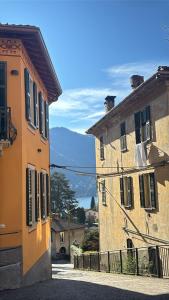two buildings are next to each other on a street at Luxury Apartment in Moltrasio Center in Moltrasio