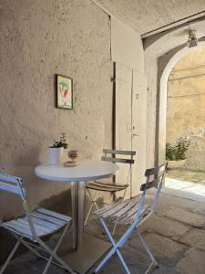 a table and two chairs sitting next to a table at Luxury Apartment in Moltrasio Center in Moltrasio