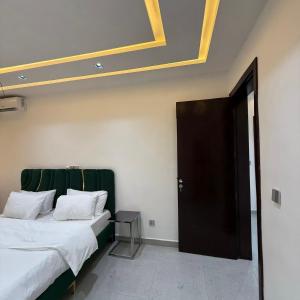 a bedroom with a bed and a black door at Houefa home résidence in Cotonou