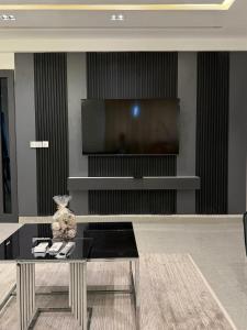 a living room with a table and a television at Houefa home résidence in Cotonou