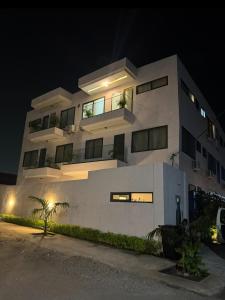 a large white building at night at Houefa home résidence in Cotonou