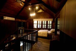 a room with a bed and a staircase in a house at Premier Cabins in North Legon