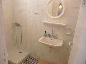 a bathroom with a sink and a toilet and a mirror at Vasilis Ios Place II in Ios Chora