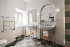 a bathroom with two sinks and two mirrors at Casa G. Firenze in Florence +43 photos