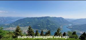 a view of a valley with a river and mountains at La Magia del Lago in Ranzanico