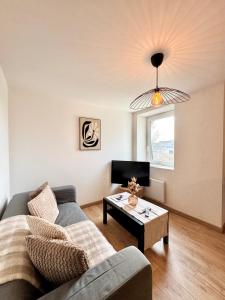 a living room with a couch and a coffee table at Chez Jacob, Centre de Rennes in Rennes