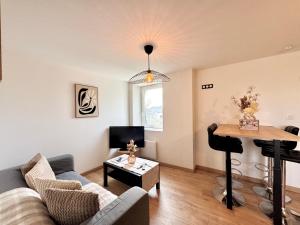 a living room with a couch and a piano at Chez Jacob, Centre de Rennes in Rennes +3 photos