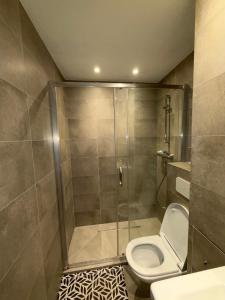a bathroom with a toilet and a glass shower at Studio in Leuven in Leuven