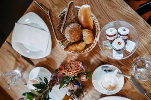 a table topped with a basket of bread and coffee at Schloss Gamlitz in Gamlitz