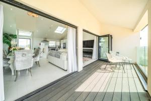 a living room with a deck with a sliding glass door at Washington Beach House in Heacham