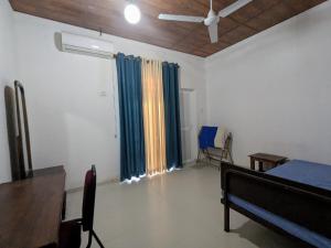 a room with a bed and a window with curtains at Prince Cottage - Entire Private Cottage in Kesbewa