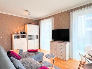 a living room with a couch and a flat screen tv at FeWo RoSi SN in Schwerin